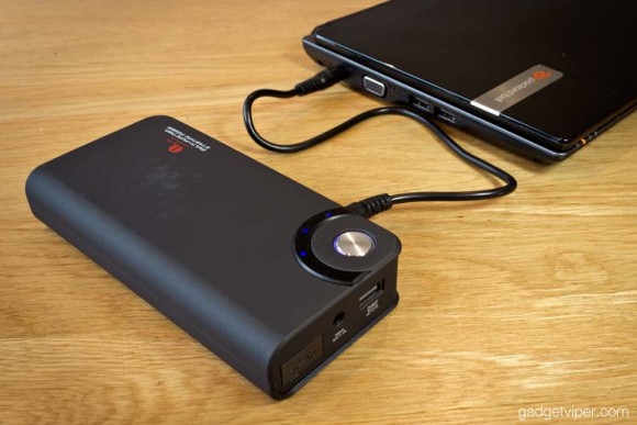 The 1byOne car jump starter charging a laptop